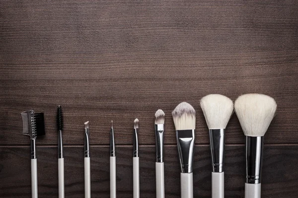 White make-up brushes on wooden background — Stock Photo, Image