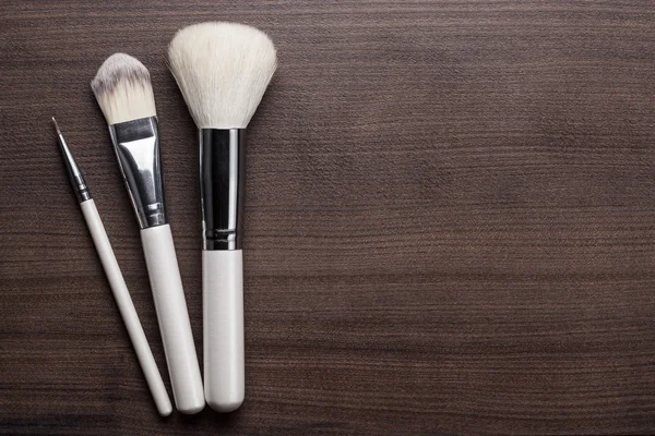 White make-up brushes on brown background — Stock Photo, Image