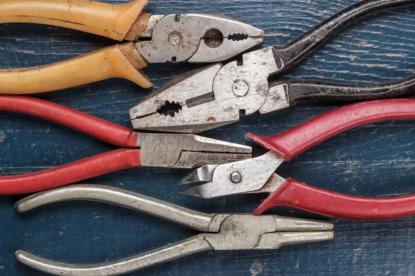 Pliers on blue table — Stock Photo, Image
