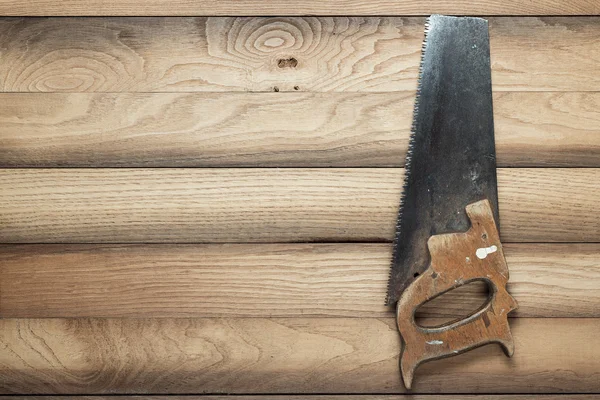 Old rusty saw on table — Stock Photo, Image