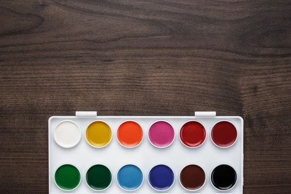 Palette with paint and brush on the table — Stock Photo, Image