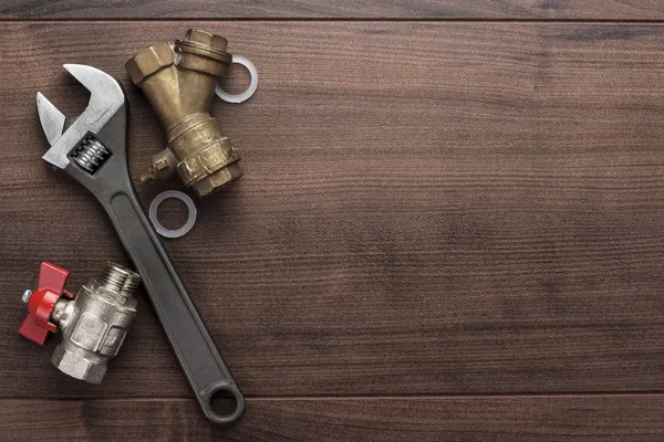 Adjustable wrench and pipes — Stock Photo, Image