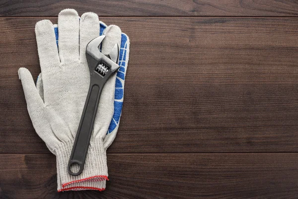 Adjustable wrench and gloves — Stock Photo, Image