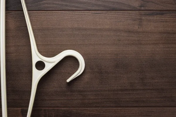 Clothing hanger on brown table — Stock Photo, Image