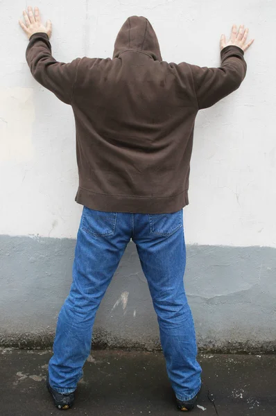 Tipo de pie con las manos en una pared — Foto de Stock