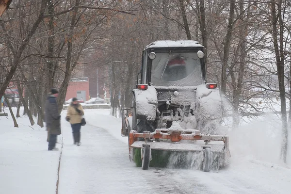 Trattore rimozione neve pulisce vicolo nel parco — Foto Stock