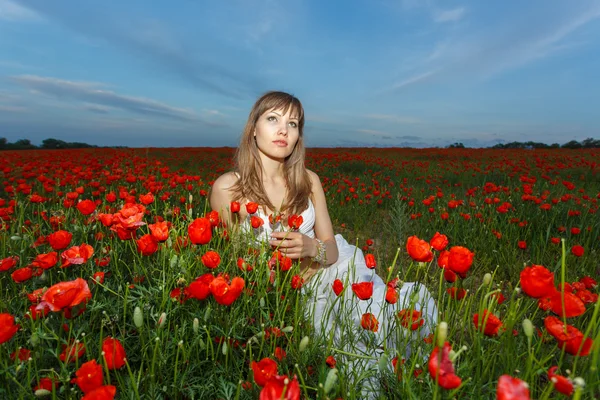Girl in a white dress in the poppy field — Stock Photo, Image