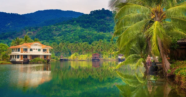 Girl on the pier tropical lake — Stock Photo, Image