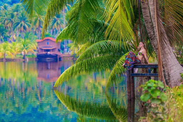 Girl on the pier tropical lake — Stock Photo, Image