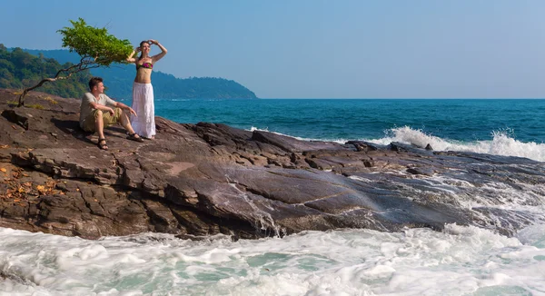 Loving couple on a rocky beach — Stock Photo, Image