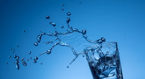 Water splashing out of a glass Stock Photo