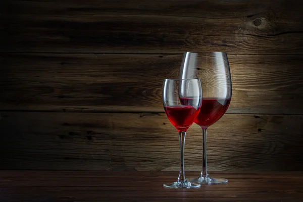 Glasses of wine on a wooden background — Stock Photo, Image