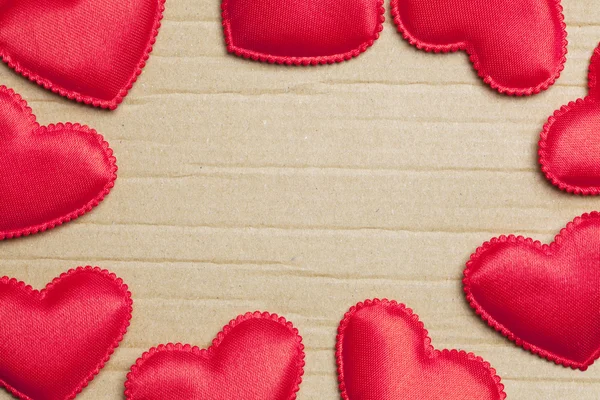 Red hearts on vintage paper background — Stock Photo, Image