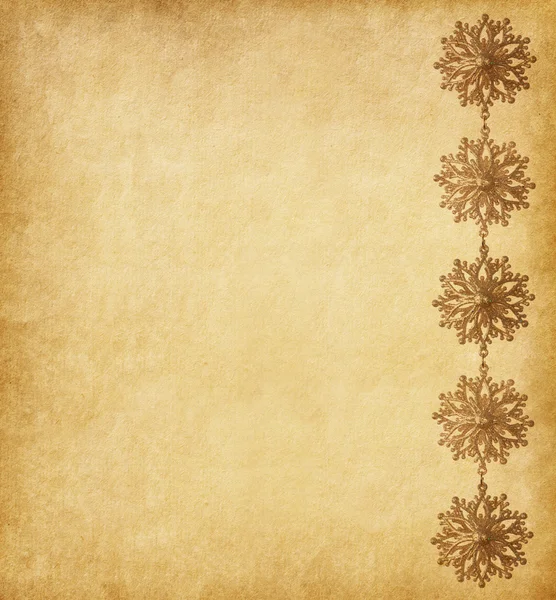 Paper background decorated with golden snowflakes — Stock Photo, Image