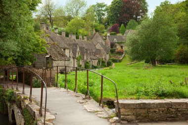 Traditional Cotswold cottages in England clipart