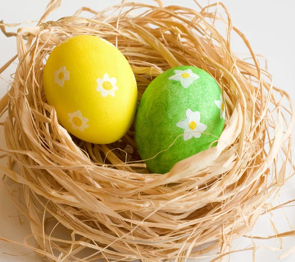 Painted eggs in the straw — Stock Photo, Image