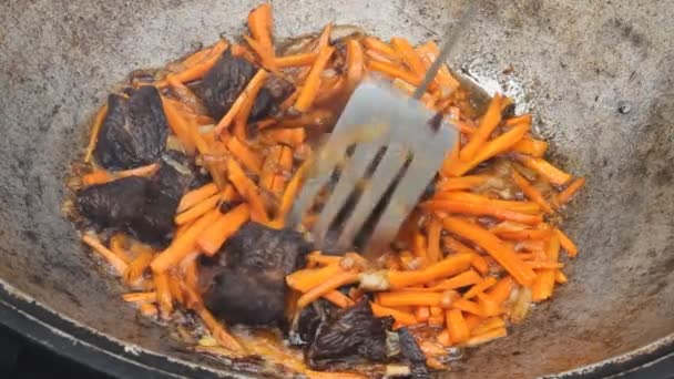 Traditional way of preparing food in a caldron — Stock Video