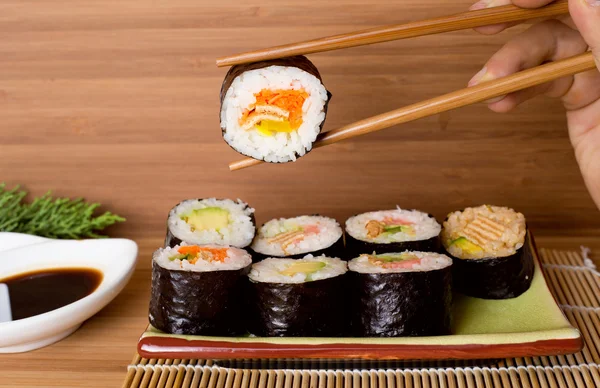 Sushi rolls on wooden background — Stock Photo, Image