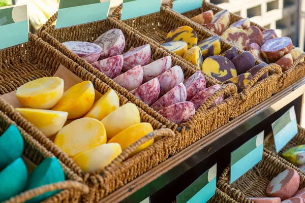 Colourful handmade soaps in baskets at the street market stall. Selective focus.