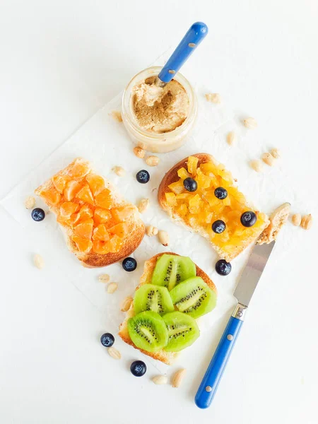 Meyveli, böğürtlenli, reçelli ve fıstık ezmeli beyaz ekmek. Sığ dof.