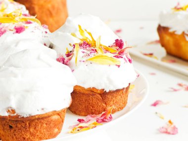 Krem şantili ve yenilebilir çiçekli kekler. Sığ dof.