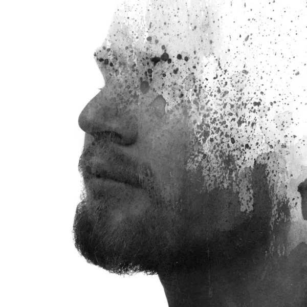 A black and white portrait of a young man combined with various watercolor splashes in a paintography technique. — Stock Photo, Image