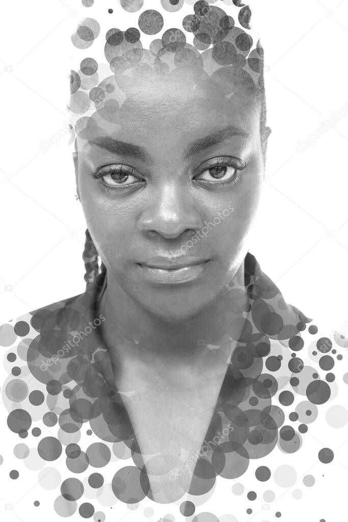 A black and white full face portrait of a woman combined with circles in a double exposure technique.