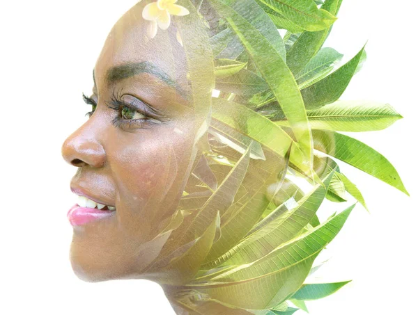 Een dubbel belicht portret van een vrouwelijk model gecombineerd met een afbeelding van groene bladeren. — Stockfoto