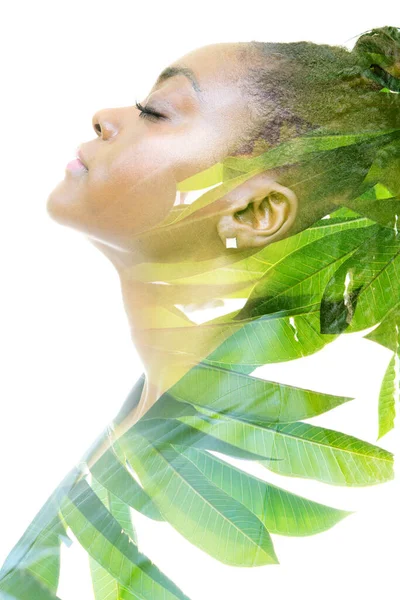 A double exposure profile portrait of a woman combined with foliage. Unity with nature. — Stock Photo, Image