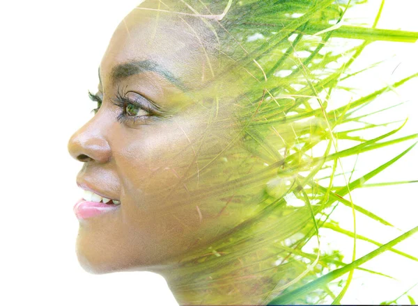 A double exposure portrait of a female model combined with an image of green grass. Life in nature. — Stock Photo, Image