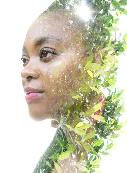 A portrait of a woman combined with foliage in a double exposure technique. — Stock Photo, Image