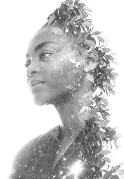 A double exposure portrait of a woman combined with an image of foliage. — Stock Photo, Image