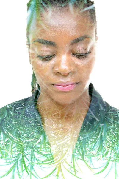 A portrait of an African American woman combined with an image of leaves in a double exposure technique. — Stock Photo, Image