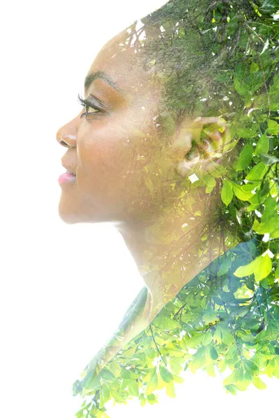 A portrait of a woman dissolving into an image of foliage. Double exposure. — Stock Photo, Image