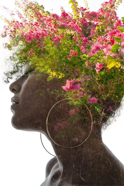 Een portret van een vrouw die oplost in bloemen in een dubbele belichtingstechniek. — Stockfoto