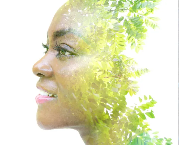 A portrait of an attractive girl combined with foliage. Double exposure. — Stock Photo, Image