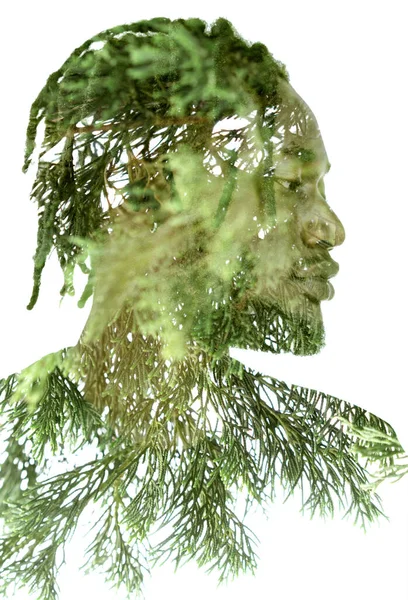 A portrait of a man combined with green twigs in a double exposure technique. — Stock Photo, Image