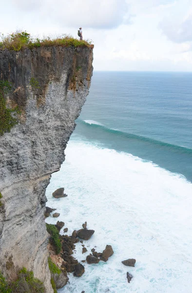 Un om stând pe o stâncă uitându-se la ocean — Fotografie, imagine de stoc