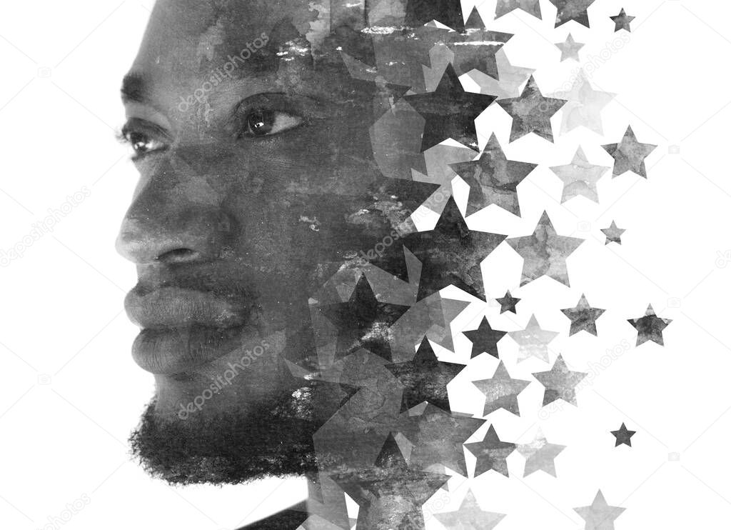 A portrait of a man combined with stars in a double exposure technique.