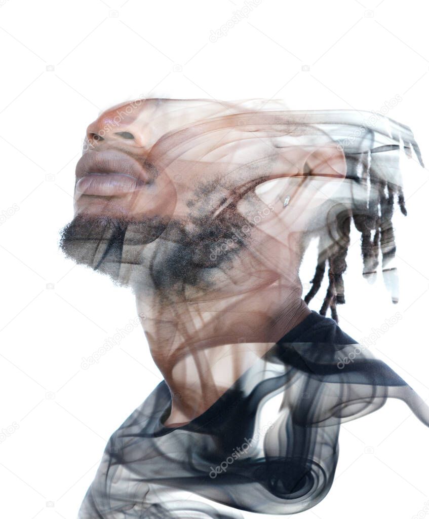 A double exposure portrait of a young man combined with an image of smoke