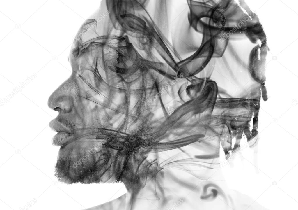 A portrait of a man combined with an image of smoke. Double exposure.
