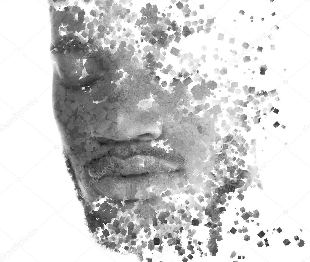 A portrait of a young man dissolving into countless particles.