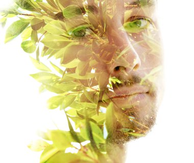 Young man looking into the camera. Double exposure.