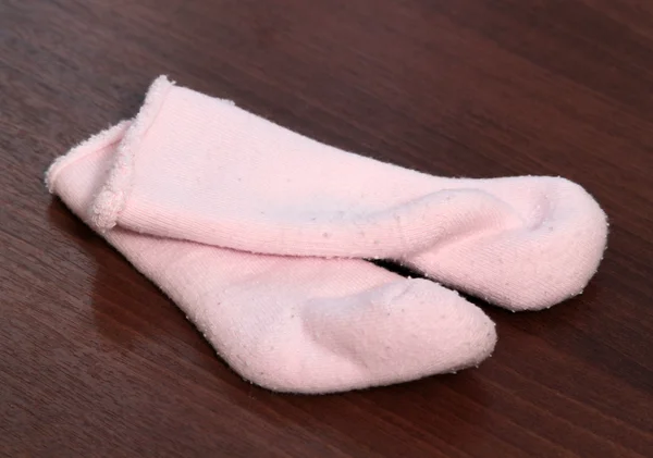 Pair of baby booties on a wooden background — Stock Photo, Image