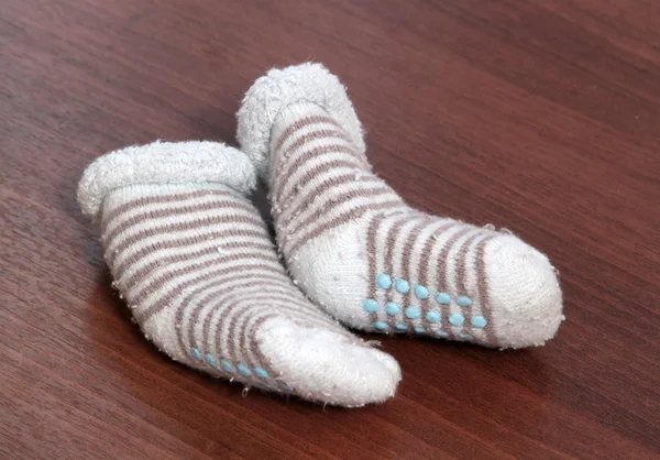Baby blue socks on wooden background — Stock Photo, Image