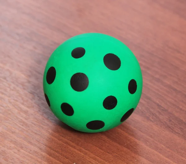 Green ball with black spots — Stock Photo, Image