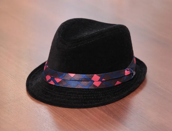 Kid black hat on wooden background — Stock Photo, Image