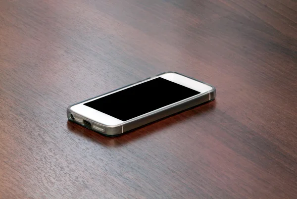 White smart phone with isolated screen on wooden desk — Stock Photo, Image