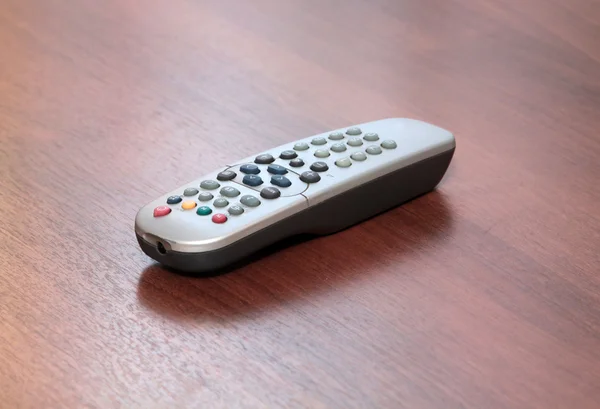 Gray remote control on wooden table — Stock Photo, Image