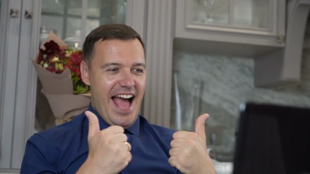 Happy man celebrating victory, business achievement looks at computer screen, working at home office — Stock video